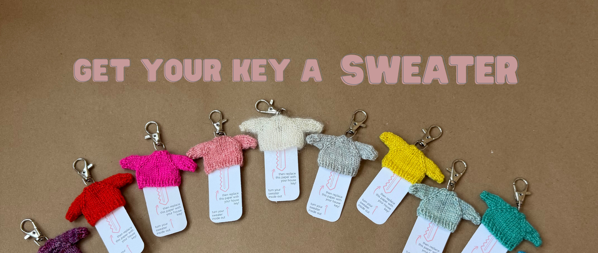 Colorful knitted sweater keychains on a brown background with text 'Get your key a sweater'.